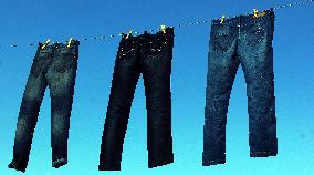 Jeans (blue)  hanging on a rope, clothes pins pegs