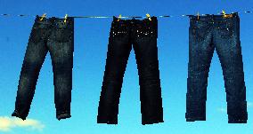 Jeans (blue)  hanging on a rope, clothes pins pegs