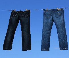 Jeans (blue)  hanging on a rope, clothes pins pegs