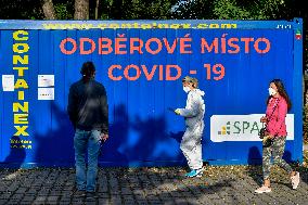 Medic in a protective suit, sample for a covid-19, testing,  test Zlute lazne, Prague