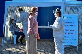 Medic in a protective suit, sample for a covid-19, testing,  test Zlute lazne, Prague