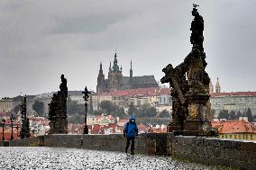 Tourist, face mask, empty Charles Bridge in Prague, without tourists, Prague Castle, panorama