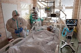 A medic nurses a patient at Intensive Care Unit