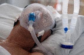 A medic nurses a patient at Intensive Care Unit
