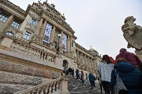 People stand a queue in front of the historical building of National Museum