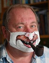 Czech cartoonist Lubomir Vanek decorates the protective face masks with cartoons, face mask