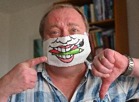 Czech cartoonist Lubomir Vanek decorates the protective face masks with cartoons, face mask