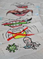 Czech cartoonist Lubomir Vanek decorates the protective face masks with cartoons, face mask