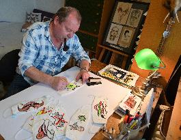 Czech cartoonist Lubomir Vanek decorates the protective face masks with cartoons, face mask