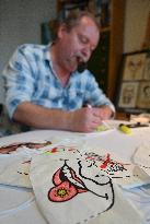 Czech cartoonist Lubomir Vanek decorates the protective face masks with cartoons, face mask