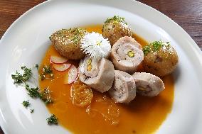 Turkey Roulade with roasted onion,  sauce, potatoes