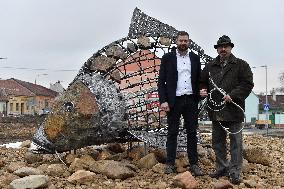 A five-metre stone and stainless steel statue of a carp, fish
