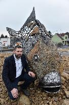 A five-metre stone and stainless steel statue of a carp, fish