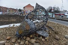 A five-metre stone and stainless steel statue of a carp, fish