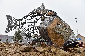 A five-metre stone and stainless steel statue of a carp, fish