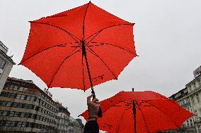 March with red umbrellas