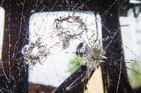 bullet hole shot through glass, tractor window