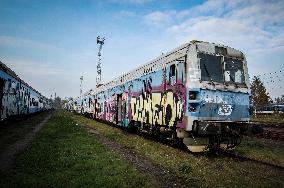 Electric train, disposal, locomotive, railway, graffiti.