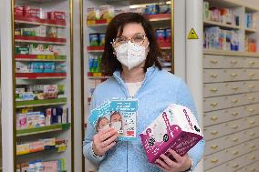 pharmacist shows packaged respirators of FFP2 and FFP3 categories, pharmacy