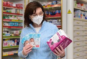 pharmacist shows packaged respirators of FFP2 and FFP3 categories, pharmacy