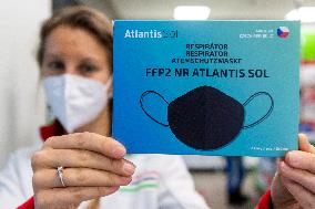 pharmacist shows packaged respirators of FFP2 category, pharmacy