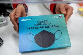 pharmacist shows packaged respirators of FFP2 category, pharmacy