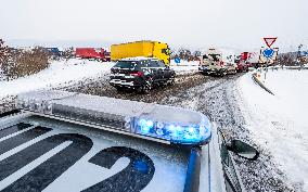 highway D8, trucks, long queue, weather, snow, winter