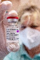 COVID-19 Vaccine AstraZeneca, ampoule, nurse