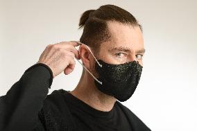 A man wearing a black face mask nano FFP2, respirator