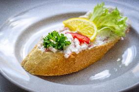 open sandwich, plate, lobster spread, vegetable, lemon.