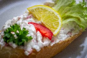 open sandwich, plate, lobster spread, vegetable, lemon.