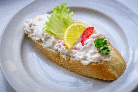 open sandwich, plate, lobster spread, vegetable, lemon.