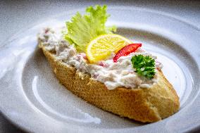 open sandwich, plate, lobster spread, vegetable, lemon.