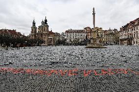 Sprayed orange words For incapable government's victims Old Town Square, Prague