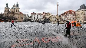 Sprayed orange words For incapable government's victims Old Town Square, Prague