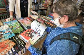 Shop with books, bookshop, customer, sales manager, face mask