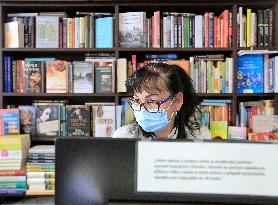 Shop with books, bookshop, customer, sales manager, face mask