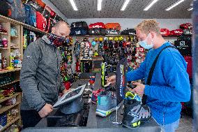 Shop with outdoor and sport equipment, sales manager, face mask