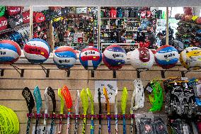 Shop with outdoor and sport equipment, sales manager, face mask
