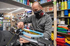 Shop with outdoor and sport equipment, sales manager, face mask