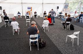 a briefing at testing point for a covid-19 test from a volunteers, journalists