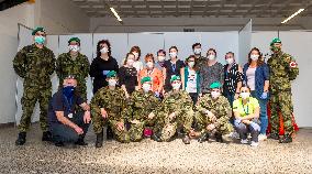 team of medics pose at testing point for a covid-19 test from a volunteers