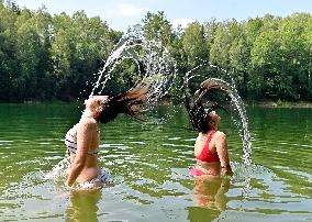 flooded quarry, woman, women, girl, girls, hair, water, summer, heat, swimsuit