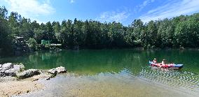 flooded quarry, water, summer, heat, boat