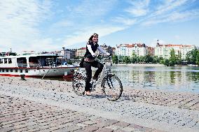 electric bike, electric powered bicycle, e-bike, cyclist, woman, Vltava river