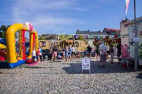 Strazov Town Hall, a fair with bumper cars, swing boats and jumping inflatable bouncing castle