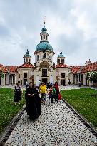 The Shrine of Our Lady Victorious at White Mountain in Prague, people, nun, mass