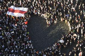 Crowds in Prague, express solidarity with Belarusian protest, people, rally, banners, Old Town Square, flag, heart