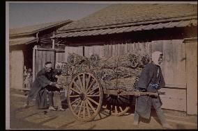 Men carrying sumi,charcoal,in daihachiguruma,a large cart