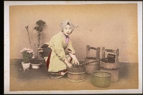 Woman washing things in a tub